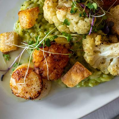 Pan seared scallops with celeriac puree and cauliflower.