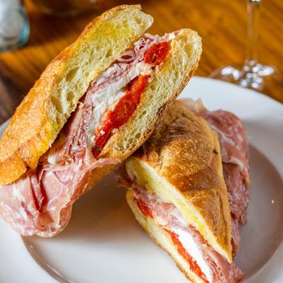 Sandwich with prosciutto, salami, red peppers, mozzarella and EVOO