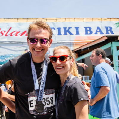 Exterior, two guests having fun, posing for a photo.