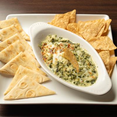 Spinach and artichoke dip served with naan and tortilla chips.