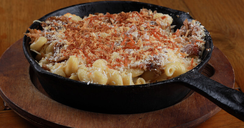 Pasta with vegetables, meat and cheese on top