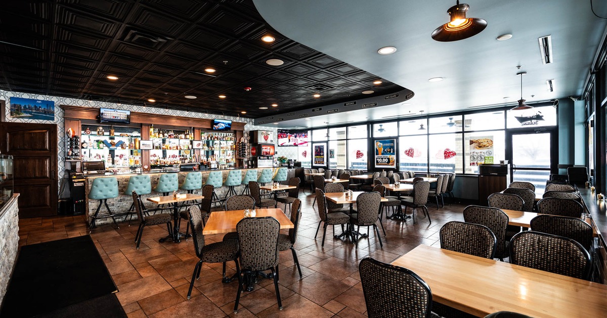 Interior, dining area, wooden top tables for two and four, entrance, large shop windows