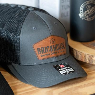 A gray trucker cap with the Brickhouse logo.