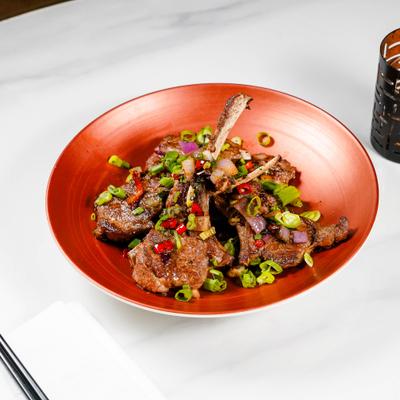 Cumin lamb chops garnished with scallions.