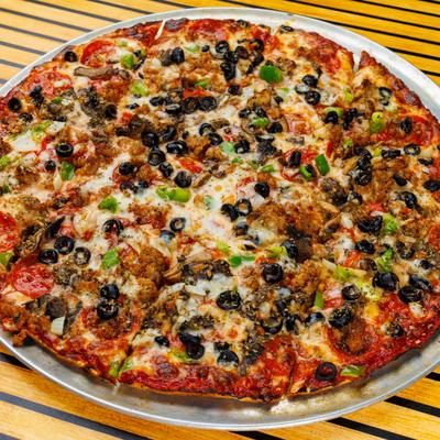 Thin Crust Deluxe Pizza with various toppings, served on a metal tray.