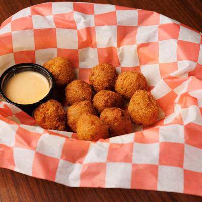 Hushpuppies with dipping sauce.