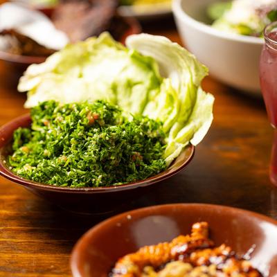 Tabouli salad plate surrounded by assorted food dishes.