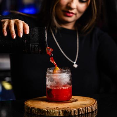 Bartender pouring a cocktail.