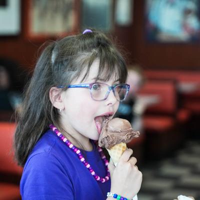happy customer eating a chocolate ice cream cone.