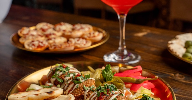Kofta ball plate, served with a red cocktail drink and other food dishes