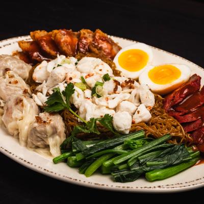 Steamed egg noodles with crab meat, pork belly, pork, shrimp wonton, veggies, and eggs.