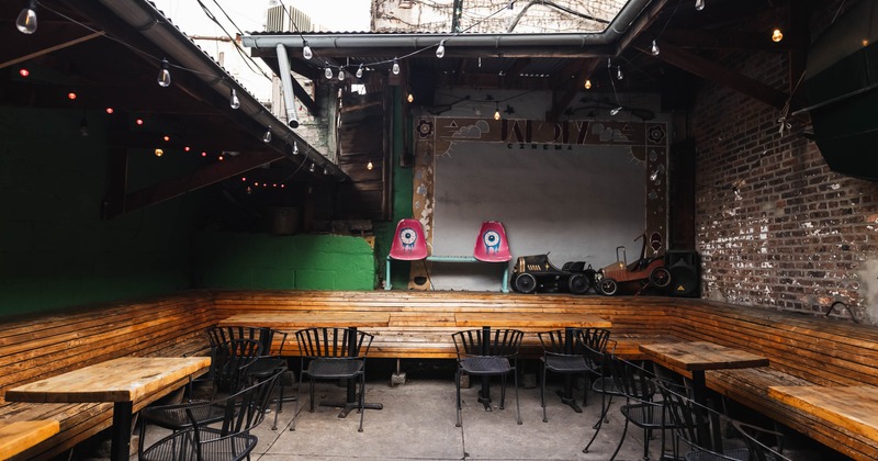 Outdoor patio with tables, chairs, string lights