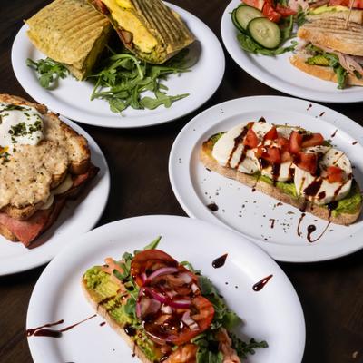 Spread of savory brunch items featuring various types of open-faced toast.
