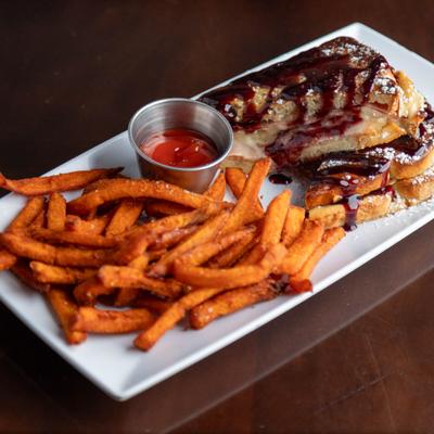 Monte cristo sandwich served with fries.