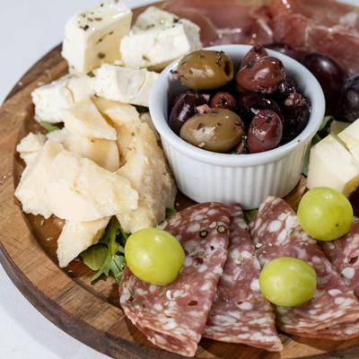 Charcuterie and cheese board with olives.