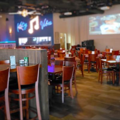 Seating area with tables and chairs.