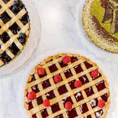 Blueberry lattice pie, raspberry lattice pie, and pistachio tart.