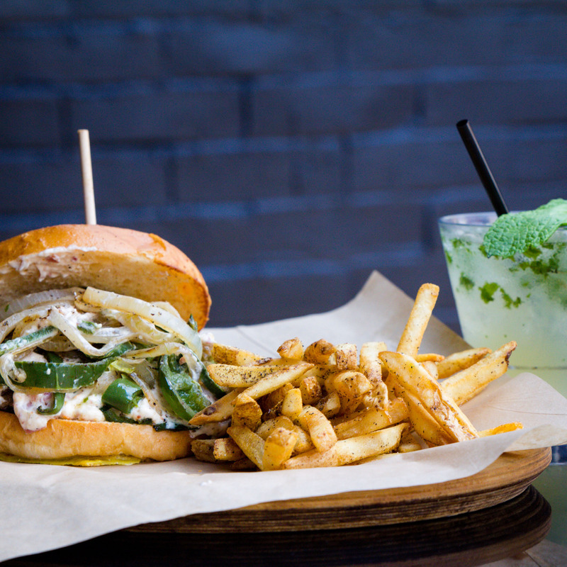 Veggie burger with fries and a mojito