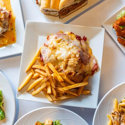 Breaded chicken topped with tomato sauce and melted mozzarella cheese, served alongside fries
