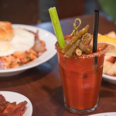 Bloody Mary, surrounded by plates of food.