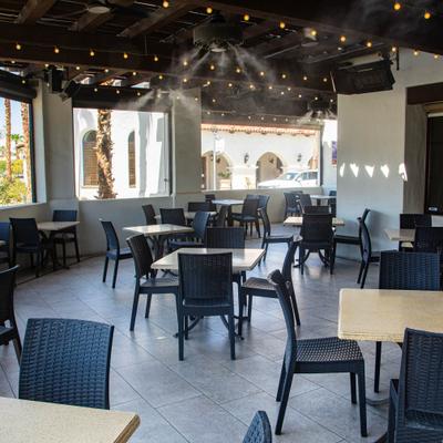Bright restaurant interior with tiled flooring and large windows.