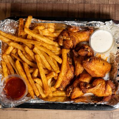 Spicy chicken wings served with fries and two dips.