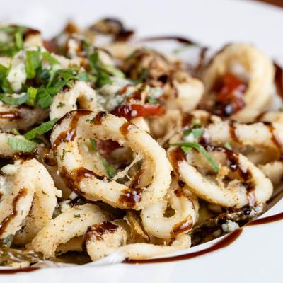 Fried calamari, with sweet and hot peppers, gorgonzola, and balsamic reduction.