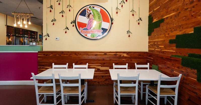 Interior space, dining area with lined up white tables and chairs