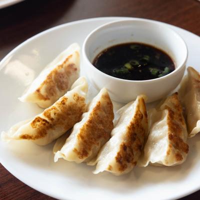 Fried dumplings served with dipping sauce.