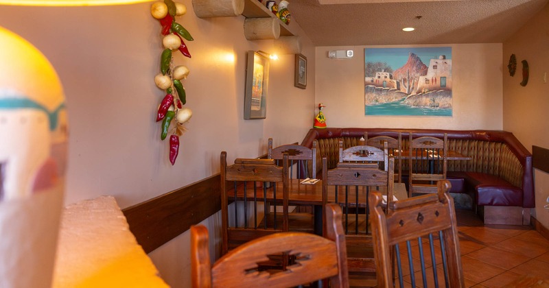 Interior, dining area, tables with chairs, "U" shaped seating booth with table in the back