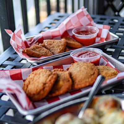 Fried mozzarella and fried green tomatoes served with tomato sauce.