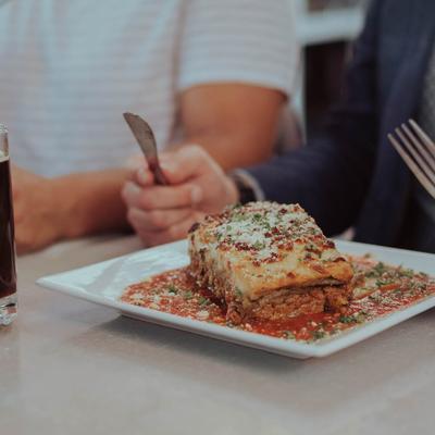 Eating lasagna.