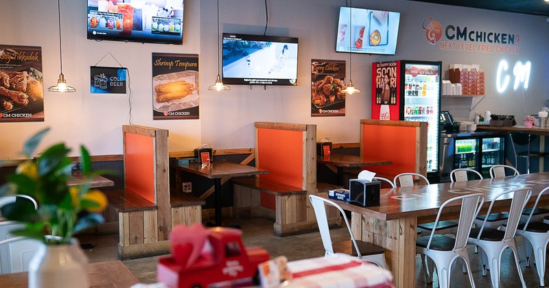 Interior, booth dining area, TV screens on the wall