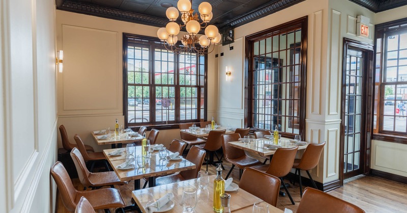 Interior, restaurant entrance, corner seating, tables and chairs ready for guests