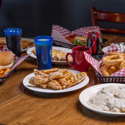 Various menu items served on the table with drinks.