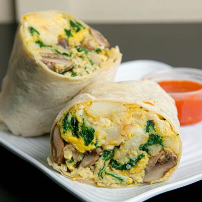 Burrito with eggs, potatoes, spinach, mushrooms, and cheese.