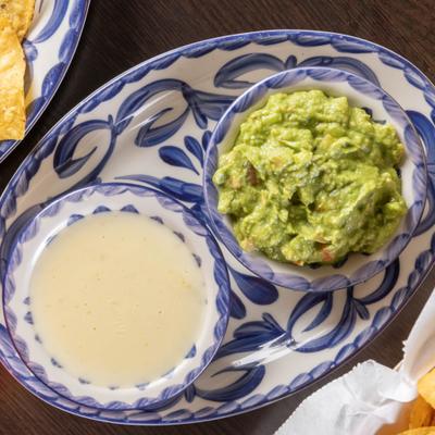 Guacamole and Cheese dip served togethet on a big plate.