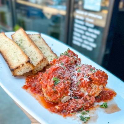 Ricotta Meatballs with marinara sauce, served with toasted bread.