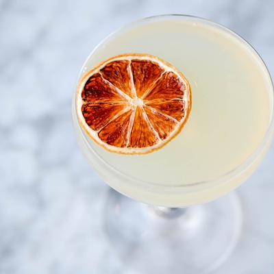 Cocktail, garnished with an orange