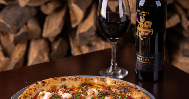 Pizza served with a glass of wine