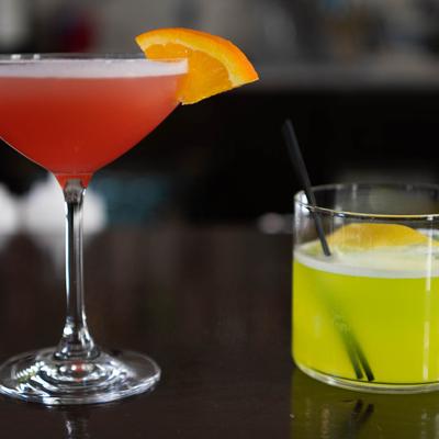 Two vibrant house cocktails.