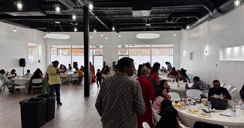 A spacious dining room filled with people enjoying food and drinks at tables