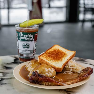 Pork Steak And Dumplings with sides and an iced drink.