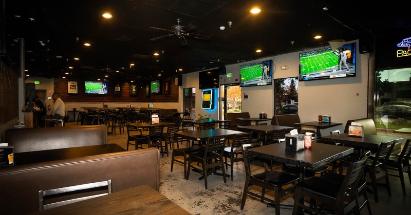 Interior, seating area with big TVs on the wall