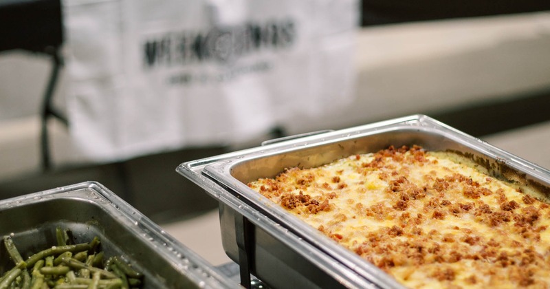 Catering buffet setup with creamy mac and cheese and green beans