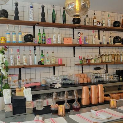 Bottles and glasses on shelves and the counter.