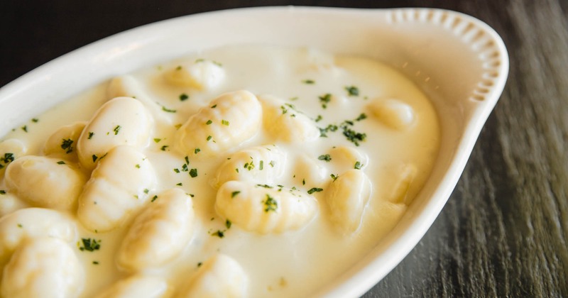 Potato dumpling with four cheeses in a white cream sauce