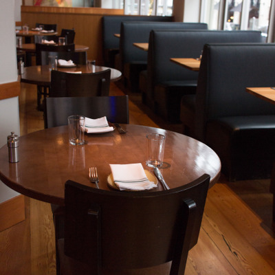 view of tables and booths by window in upper dining area