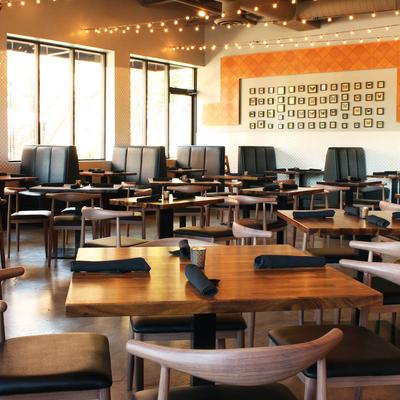 The interior featuring a spacious dining area with numerous tables and booths.