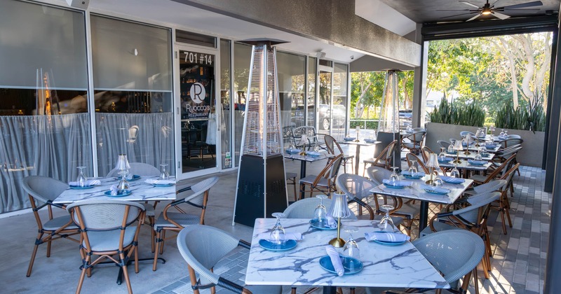 Exterior, patio, tables for two and four, restaurant entrance, space heaters